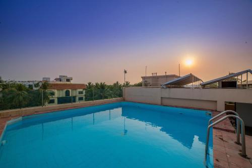 a large blue swimming pool on top of a building at Raj Park Hotel Chennai in Chennai