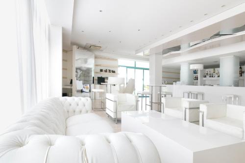 a white living room with white chairs and a white couch at Hotel Excelsior in Vasto