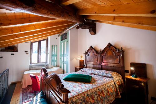 a bedroom with a bed in a room with wooden ceilings at Antica Molina in Faggeto Lario 