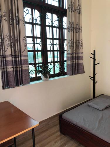 a bedroom with a bed and a window at Cao Bang Eco Homestay in Cao Bằng