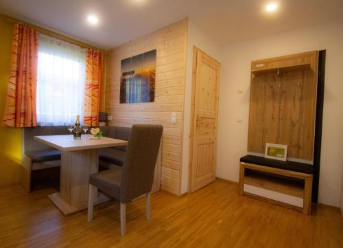 a dining room with a table and chairs and a door at Appartement Sonnblick Kuschelsuite in den Bergen in Großsölk