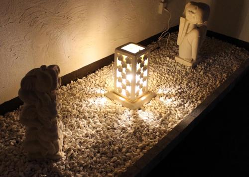a lantern with lights on a bed of rocks at Hida Takayama Hotel Viera Resort (Adult Only) in Takayama