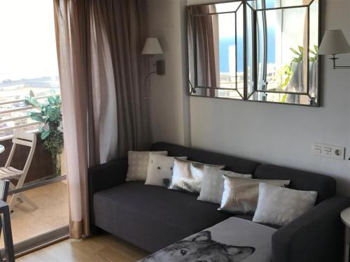a living room with a couch and a mirror at Alicante Top Sea View 29th Apts Downtown&Beach in Alicante