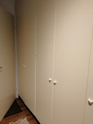 a room with white cabinets and a rug at Sun Apart Vuorenrinne in Kotka