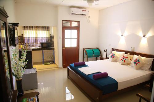 a bedroom with a large bed in a room at Aken villa in Hikkaduwa