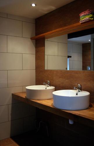 two sinks on a counter in a bathroom at B&B La Belle Histoire Laforêt in Laforêt