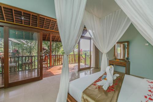a bedroom with a bed with a stuffed animal on it at Villa D'Carik Bali in Denpasar