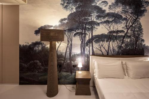 a bedroom with a bed and a painting on the wall at Isola di San Servolo - Centro Soggiorno in Venice
