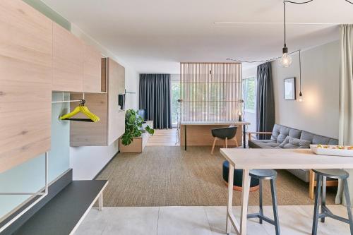 a living room and dining room with a dining table at Designhotel Whitman in Ascheberg