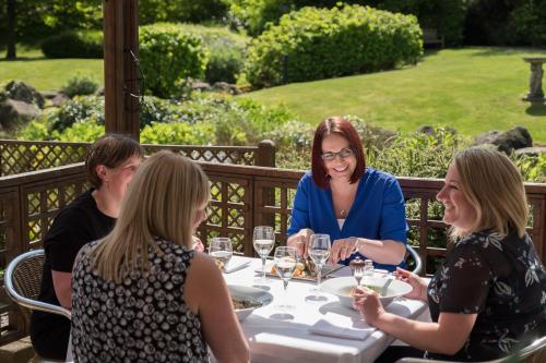 a group of women sitting around a table with wine glasses at Kettering Park Hotel and Spa in Kettering