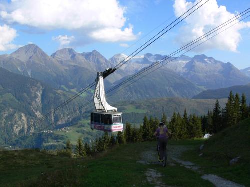 a person riding a bike on a mountain with a cable car at Apartment in Disentis in Disentis