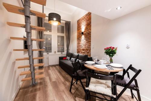 a dining room with a table and a couch at DIETLA 99 APARTMENTS - IDEAL LOCATION - in the heart of Krakow in Kraków