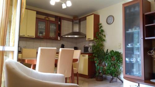 a kitchen with a table and chairs and a clock at Apartment Tatjana in Vis