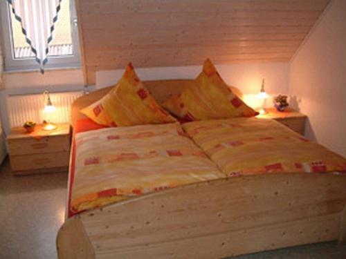 a bedroom with a bed with two pillows on it at Ferienhof Winkler in Merkendorf