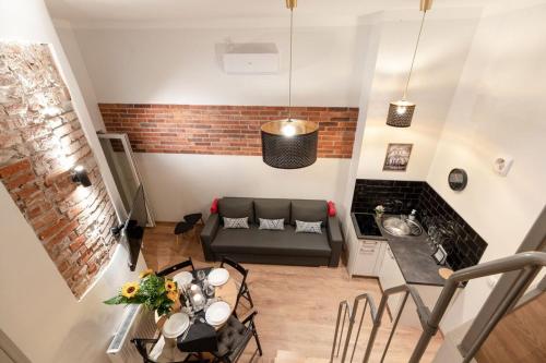 a living room with a couch and a table at DIETLA 99 APARTMENTS - IDEAL LOCATION - in the heart of Krakow in Kraków