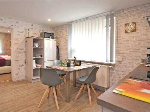 a kitchen with a table and chairs in a room at Holiday flat in Ernstroda near a ski resort in Friedrichroda