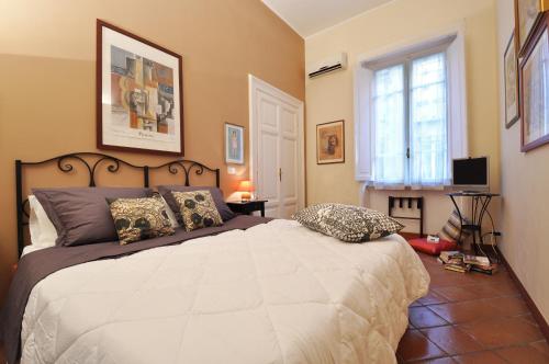 a bedroom with a large bed and a window at Casa Visconti in Rome