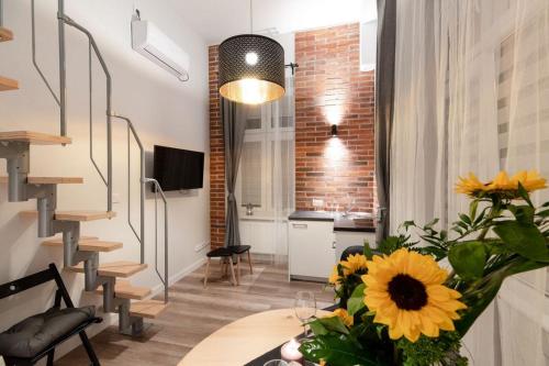 a room with a table with a vase of flowers at DIETLA 99 APARTMENTS - IDEAL LOCATION - in the heart of Krakow in Kraków