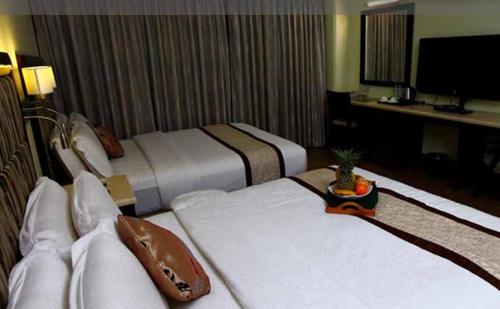 Ένα ή περισσότερα κρεβάτια σε δωμάτιο στο Diamond Suites and Residences