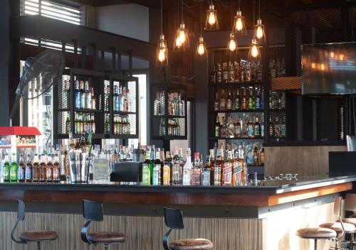 a bar with a lot of bottles of alcohol at Dang Derm In The Park Khaosan in Bangkok
