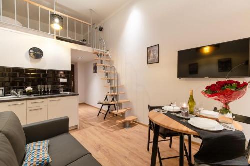 a kitchen and a living room with a table and chairs at DIETLA 99 APARTMENTS - IDEAL LOCATION - in the heart of Krakow in Kraków