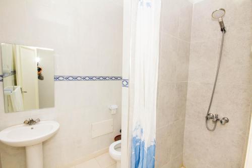 a bathroom with a shower and a sink and a toilet at Appart Hotel Wassila in Nador