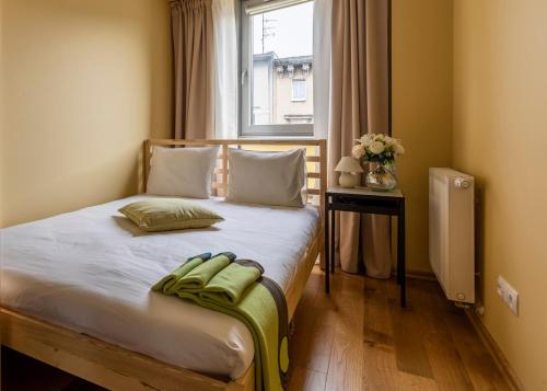 a bedroom with a large bed with a window at Apartament Brandy in Szczecin
