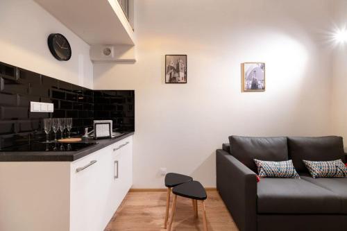a living room with a couch and a counter at DIETLA 99 APARTMENTS - IDEAL LOCATION - in the heart of Krakow in Kraków