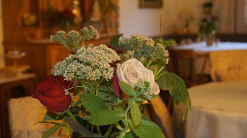 a bouquet of flowers in a vase on a table at Pension Hartenfels in Lech am Arlberg