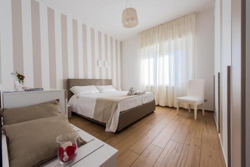 a bedroom with a bed and a couch at B&B Aries in Casarano