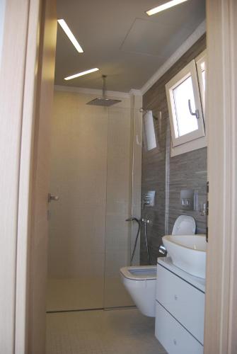 a bathroom with a shower and a toilet and a sink at Sunrise Studios Resort in Skala Potamias