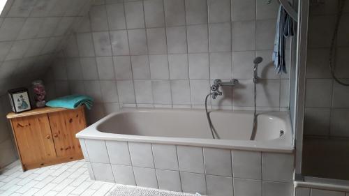 a bath tub with a shower in a bathroom at Ferienwohnung Mai in Gittelde