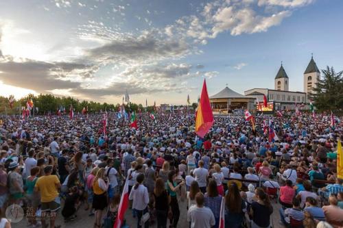 a large crowd of people holding red and yellow flags at Spacious 80m2 Apartment in the Center in Ljubuški