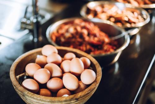 a basket of eggs on a table with other food at Der LIPPISCHE HOF in Bad Salzuflen