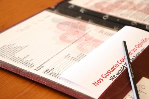 a book on a table with a medical check on it at Olimpo Hotel & Suites in Itauguá