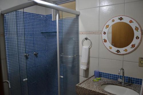 a bathroom with a shower and a sink and a mirror at Hotel Casa De Praia in Fortaleza