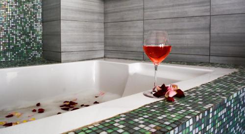 a glass of wine sitting in a bath tub at Bliss Resort in Nyali