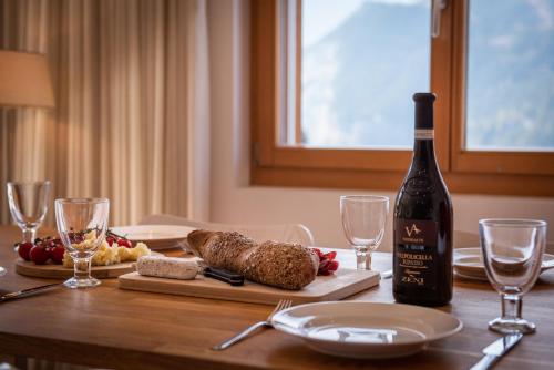 a table with a bottle of wine and food on it at Chalet Am Acher 7 in Wengen