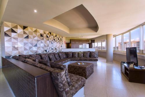 a large living room with a couch and a television at Bliss Resort in Nyali