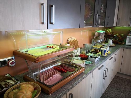 a kitchen with a counter with meat and other foods at Ferienparadies Gutounik in Pörtschach am Wörthersee