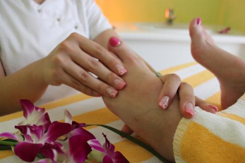 a woman with her feet on a table with flowers at Best Western Plus Ostseehotel Waldschloesschen in Prerow