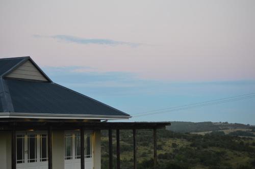 a house with a black roof with a view at Premier Resort Mpongo Private Game Reserve in Macleantown