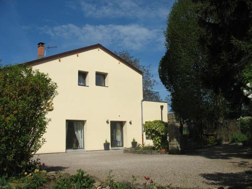 a white building with two windows on top of it at LES JARDINS DE LA GRANGE in Rezonville
