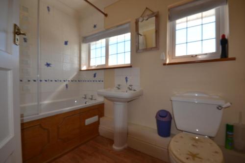 łazienka z umywalką, toaletą i wanną w obiekcie 4 Brooks Close w mieście Bembridge