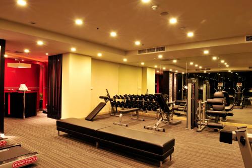 a gym with treadmills and machines in a room at Amaranth Suvarnabhumi Hotel - Free Suvarnabhumi Airport Shuttle in Lat Krabang