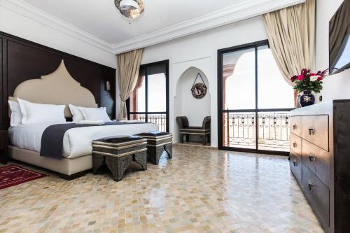 a hotel room with a bed and a balcony at VILLA ILYANA in Marrakesh