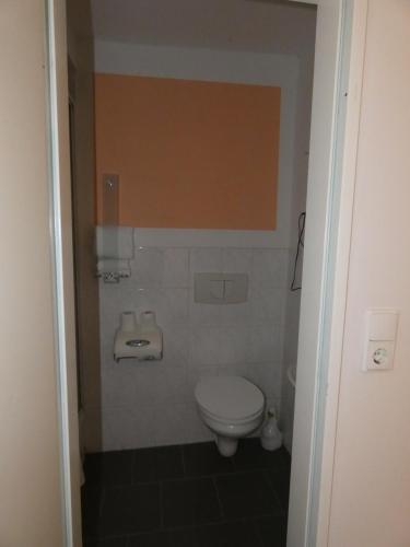 a bathroom with a toilet and a sink at Hotel Wolters in Bremen
