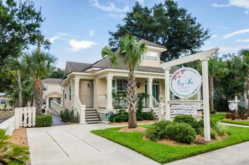 a house with a palm tree in front of it at The Cozy Inn in St. Augustine