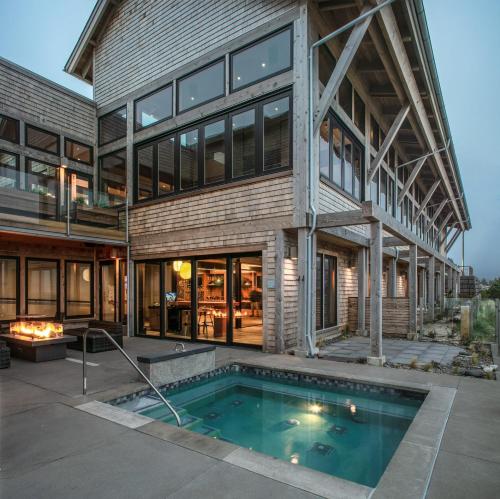 an exterior view of a house with a swimming pool at Headlands Coastal Lodge & Spa in Pacific City