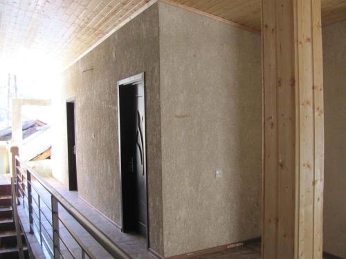 a hallway in a house with a door in the wall at Jeiran Japaridze's Guesthouse in Mestia
